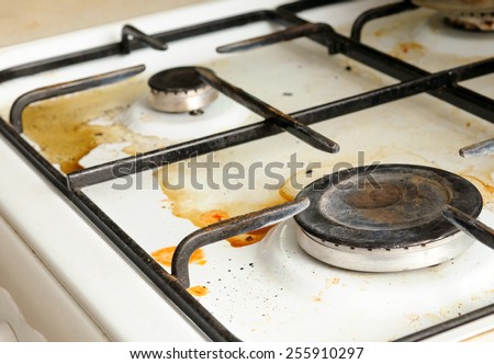 Dirty gas stove burners in kitchen room