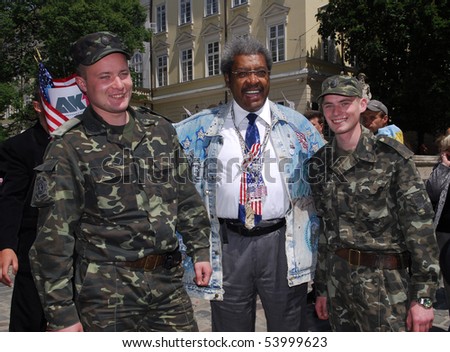 LVIV, UKRAINE - MAY 25: American boxing promoter Don King takes a photo with ukrainians soldiers in Lviv, on May 25, 2010 to announce that former WBA champion Andriy Kotelnik signed a contract.