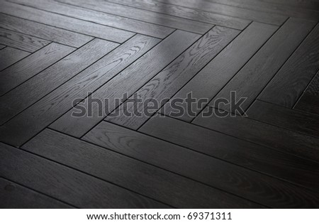 background black wooden parquet floor herringbone pattern