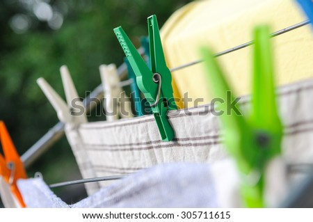 Close-up of colorful laundry pins and hanged clothes drying