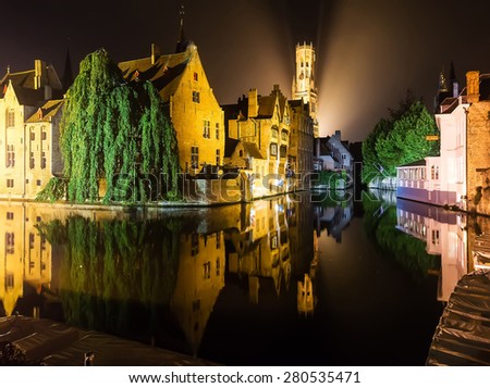 Medieval european city Brugge in lights by night  reflected in the water
