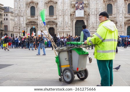 MILAN, ITALY - March 14:street cleaner look at children and parents joining the Andemm al Domm parade on March 14, 2015 in Milan, Italy.
