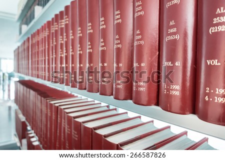 row of classic books in modern office bookshelf