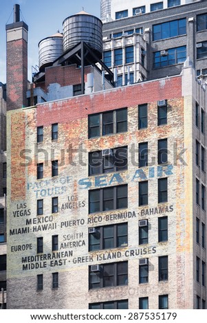 NEW YORK CITY - JUNE 14, 2015: faded ads on old brick building on the Eighth Avenue and 39th Street