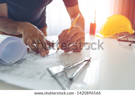 Construction engineer working at blueprint to build large commercial buildings at home ストックフォト © 
