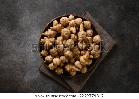 Similar – Image, Stock Photo Plate with raw Jerusalem artichoke on concrete kitchen table with olive oil, herbs and spices. Cooking preparation at home with root vegetable. Top view.