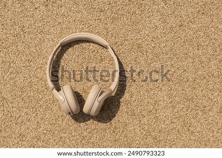 Similar – Image, Stock Photo beige wireless headphones on a purple background