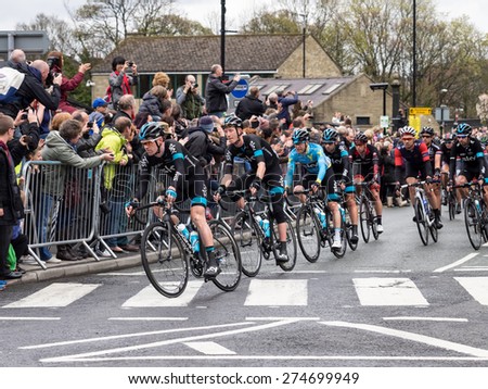 Holmfirth, UK - May  3rd, 2015: The peleton of the 2015 Tour de Yorkshire cycle race passes through the town of Holmfirth