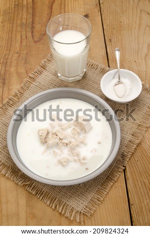 yeast in a bowl with warm milk and sugar on jute