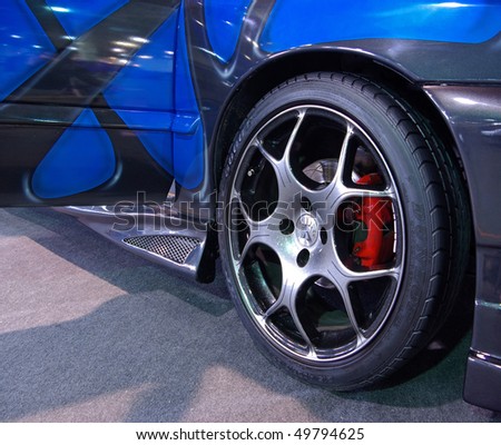 BUDAPEST - MARCH 19: Light-alloy wheel of a blue tuned car with special brake on international tuning show with reflector lights in Hungexpo on March 19, 2010 in Budapest, Hungary