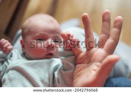 baby girl holding mother finger. Grasping reflex of newborn Сток-фото © 