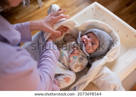 putting on warm clothes on baby girl preparing for a walk on cold winter day. Photo stock © 