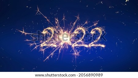 Happy New Year 2022. Sparkling burning 2022 Year on blue background. Beautiful creative template for design Christmas holiday greeting card, flyer, billboard and Web banner