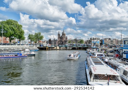 AMSTERDAM, MAY, 28, 2015. Canal and tour-boat. Amsterdam is known as Venice of the North, it has 1,200 bridges and 165 canals. Best way to experience them is one of the boat tours.