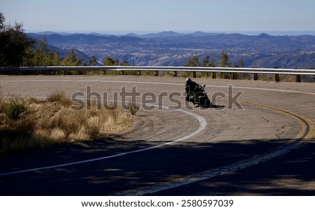 Similar – Foto Bild Mountainbiker aufgestützt auf Fahrradlenker blickt in die Ferne.