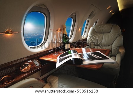 luxury interior in the modern  business jet and sunlight at the window/sky and clouds through the porthole ストックフォト © 