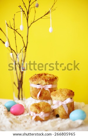 Orthodox Easter traditional bread Kulich, Panettone baking with easter eggs decoration on a branch. Depth of field