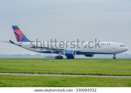 Schiphol, Noord-Holland/Netherlands - October 21-10-2015 - Aircraft from Delta Air Lines 3315 is landed at the airport. The plane wil drive to the passenger boarding bridge. foggy sky background.