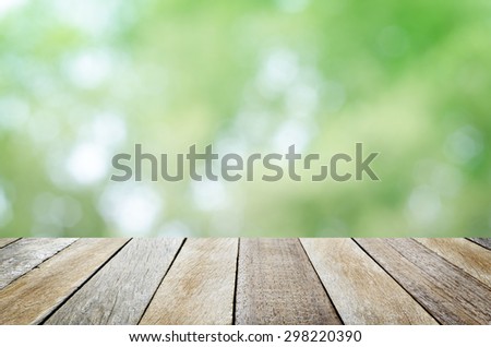 Empty Wooden Table with Fresh Foliage Abstract Circle Bokeh Background for Product or Object Montage Display