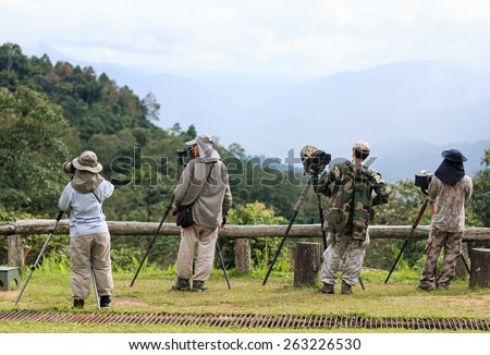 KAMPHAENG PHET, THAILAND - JULY 26, 2014:Bird Watchers are been waiting the birds to be targeted in a national park.in Kamphaeng Phet, Thailand