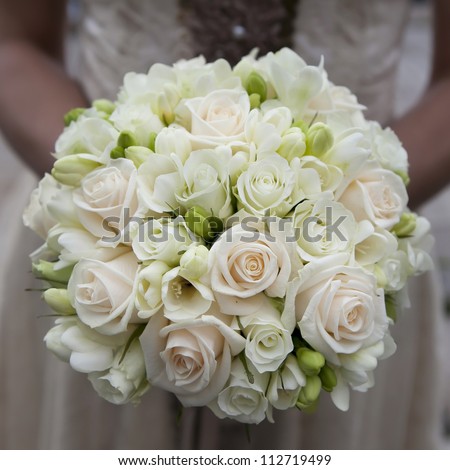 the bride holding wedding bouquet of pink and white  roses