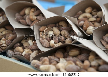 Close-up of assorted nuts in paper bags. Top view point.
