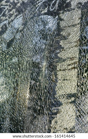 Broken glass-cracked windshield with hole