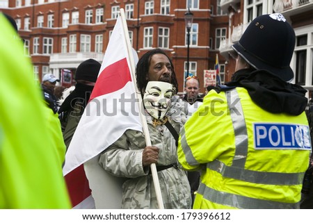 LONDON, UK - MARCH 1TH 2014. London protesters march against worldwide government corruption. Protester agrue with policemen. In London on 1th March 2014.