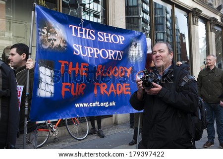 LONDON, UK - MARCH 1TH 2014. Protesting against the fur trade outside Harvey Nichols. written on a poster: This shop supports the bloody fur trade.  In London on 1th March 2014.