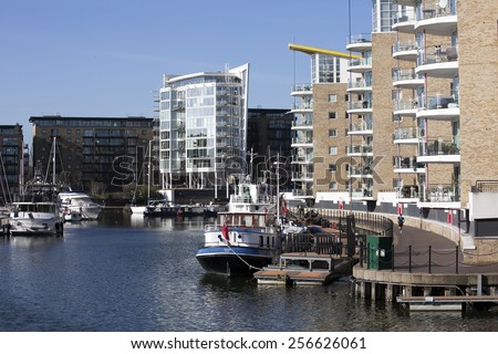 LONDON, UK - 15 JUNE 2014: Limehouse basin in the centre of London, private bay for boats and yatches and flats with Canary Wharf view