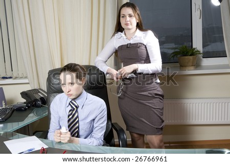 Boss has a bad mood. Secretary try to suggest to boss coffee. Interior of office. Office people.