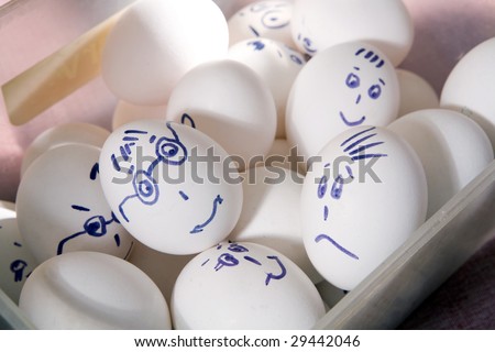 Hen`s eggs in box. Eggs cover with drawings. Look like man`s face