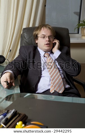 tired boss speaking by phone sitting on chair. Office people