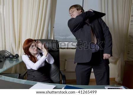 Business team over modern office background. Furious clerk beats boss. Office people.