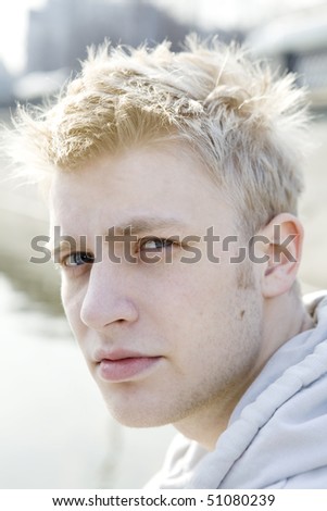 close up portrait of blond man with blue eyes