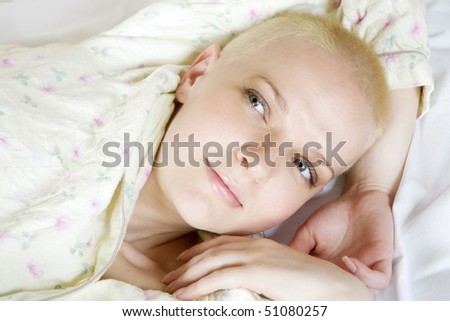 portrait of short hair blond smiling woman in bedroom