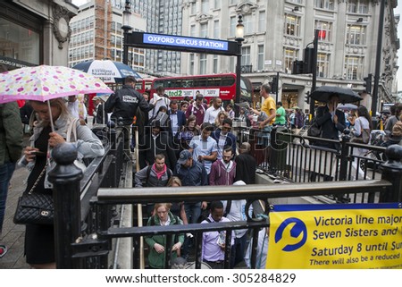 LONDON - AUG 10 : Crowd passing oxford circus on Aug 10, 2015, London, UK. Oxford Circus, busy intersection with Regent Street, is  biggest shopping street in Europe, visited by millions of tourists