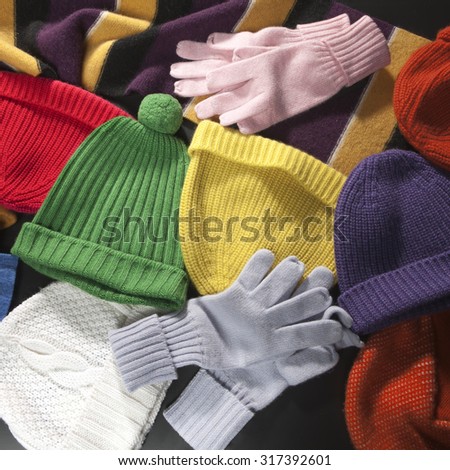 Colorful woolen scarf, hats and gloves background