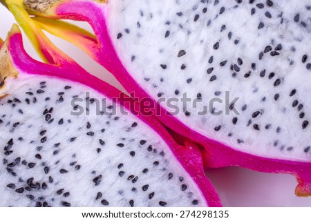 Dragon fruit halved close-up cropped and isolated on a white background shot diagonally landscape