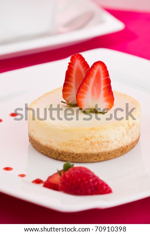 Strawberry cheese cake on a white plate. Shallow depth of field.