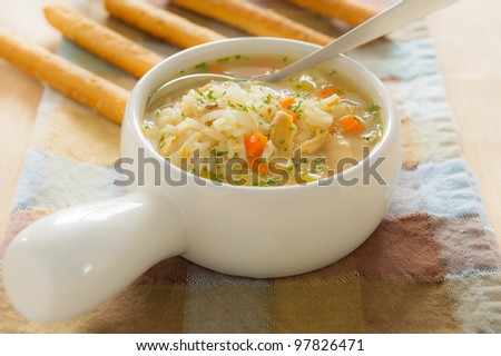 Healthy chicken rice soup with spoon. Shallow depth of field.