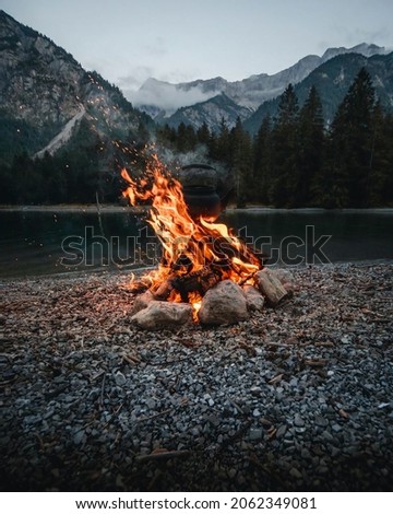 Isolated campfire in nature. campfire in nature with river and forest view. campfire with fire blazing for wallpaper, background