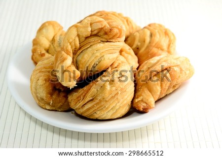 Curry puff  in white plate on bamboo pad plate