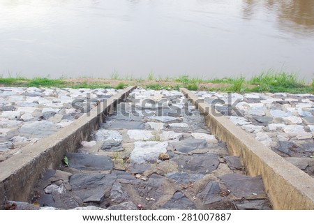 The stone way to the river , lake , cement way
