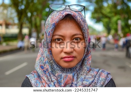 portrait of a beautiful young asian woman in hijab with a sullen expression looking at the camera Foto stock © 