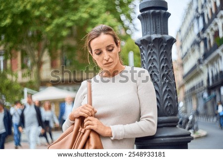 Similar – Image, Stock Photo thoughtful woman leaning on wall