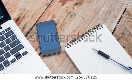 mobile phone laptop  notebook on table