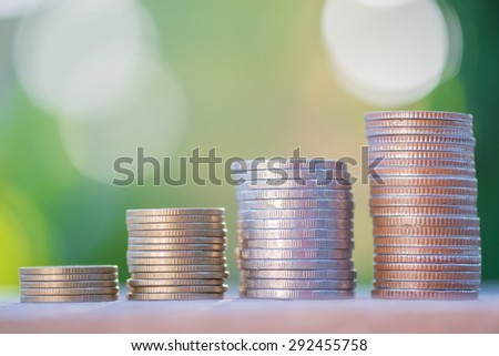 increasing stack of money coins, saving money.