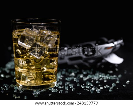 Glass of alcohol on a black background and an accident of simulated car