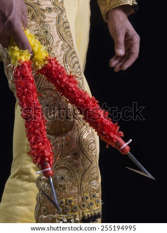 Bullfighter dressed with suit of lights with barbed of sticks in the hands